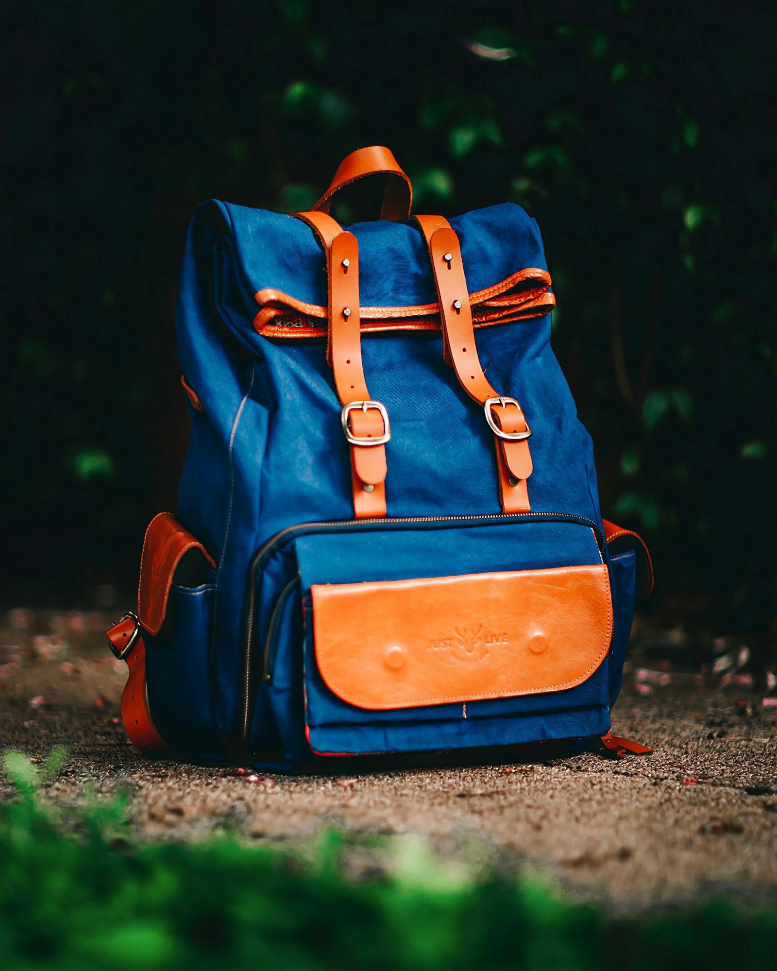 Elegant blue backpack with brown leather accents, ideal for travel and adventure.